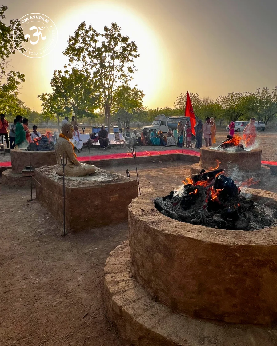 View of the Panch Dhuni with the sun shining like a white fire ball above at OM Ashram.